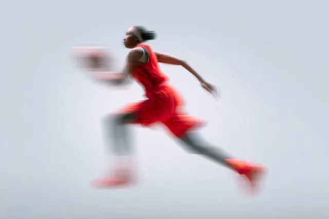 A blurred silhouette of a [Subject] in motion, wearing a ...