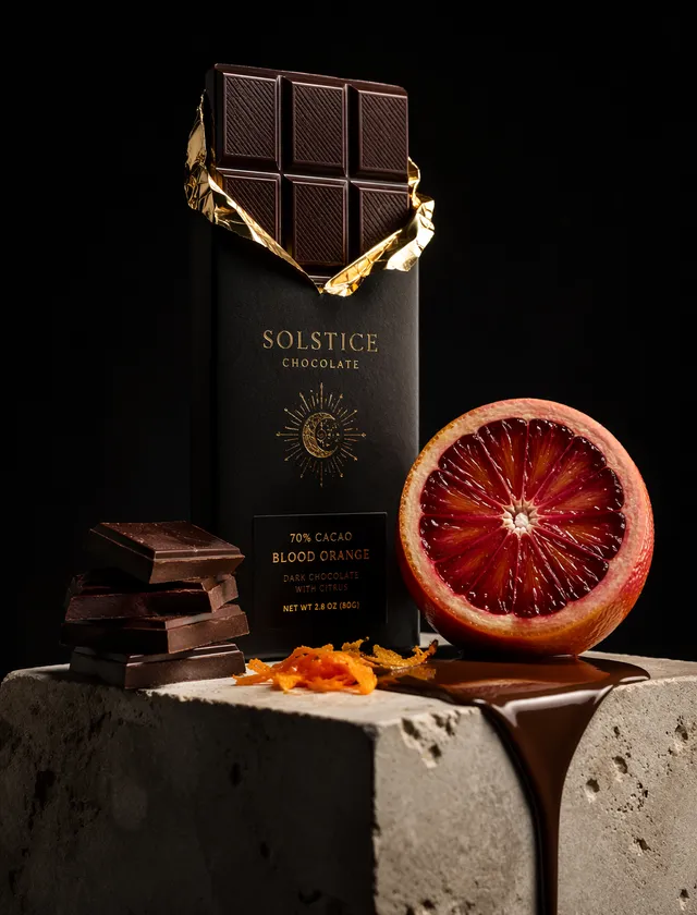 A premium dark chocolate bar wrapped in matte black paper...