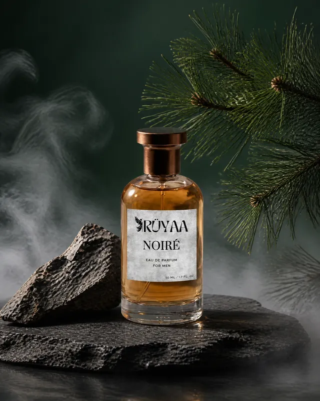 A perfume bottle sits centered on a rough-hewn slate slab...