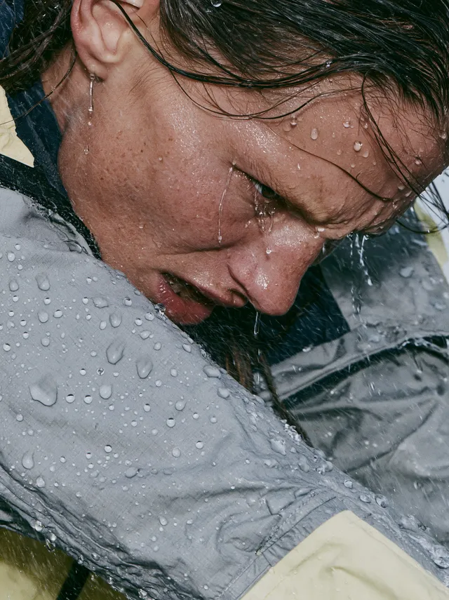 Heavy natural rainfall surrounds the model, with fine rai...